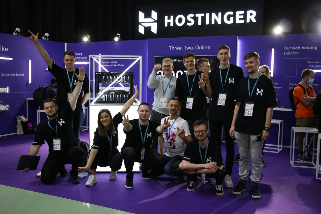 Hostinger team at the booth in WordCamp Europe 2022