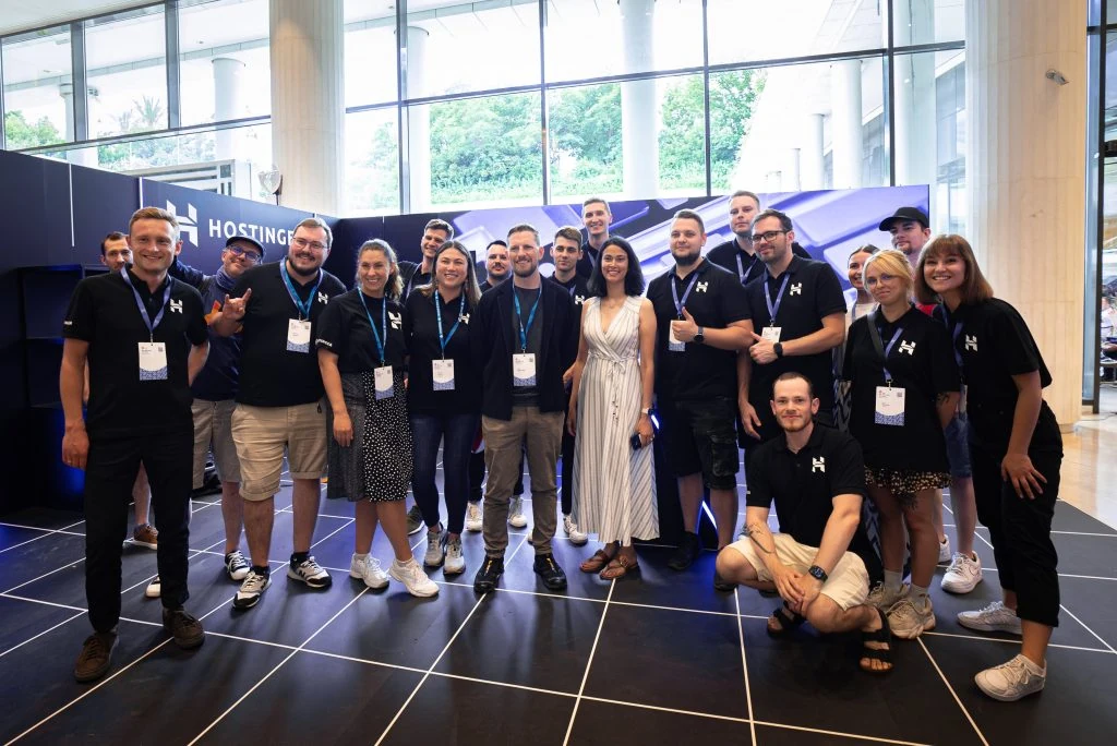 Hostinger team with Matt Mullenweg and Josepha Haden Chomphosy at Hostinger's booth in WCEU 2023