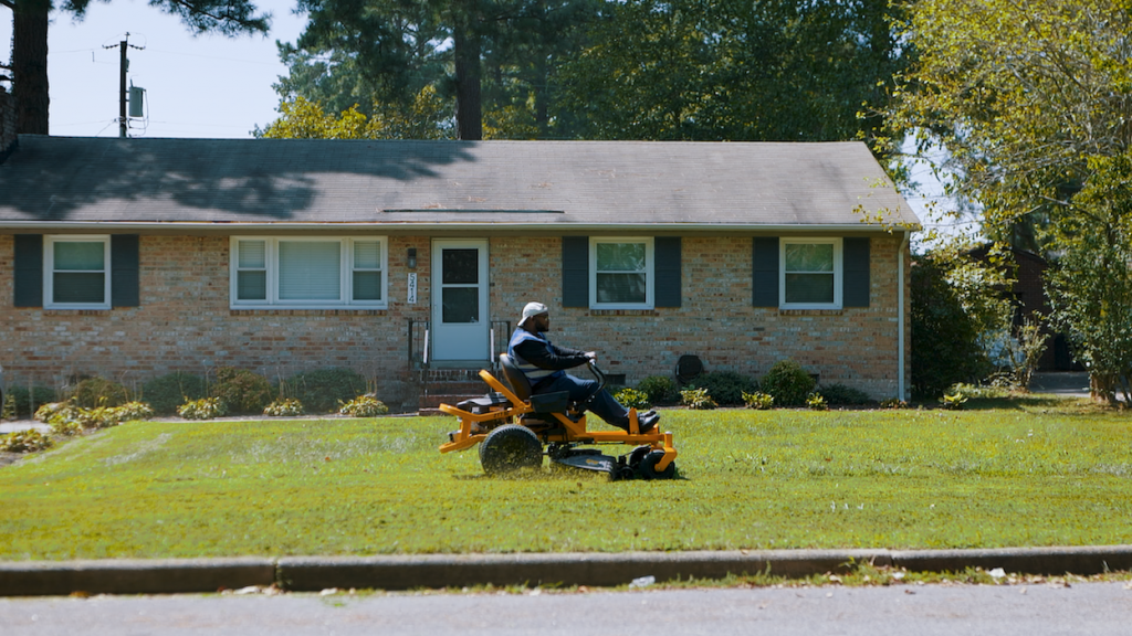 Jarrott mowing a lawn.