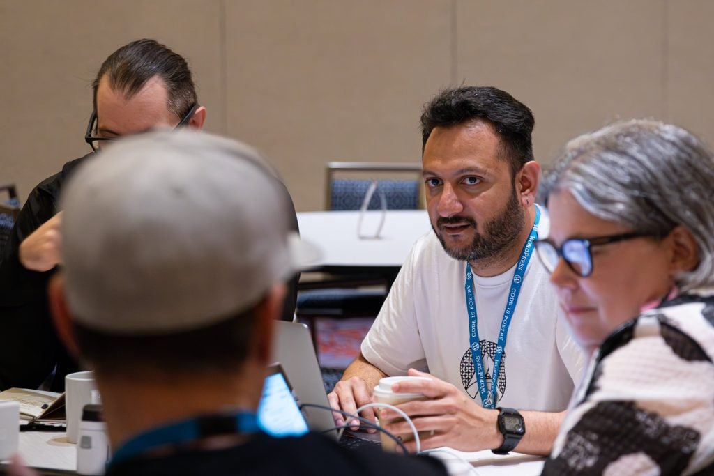 Hostinger Affiliate Partnerships Manager Aditya Remy Shah during a discussion at the Sustainability team table at WordCamp US 2023