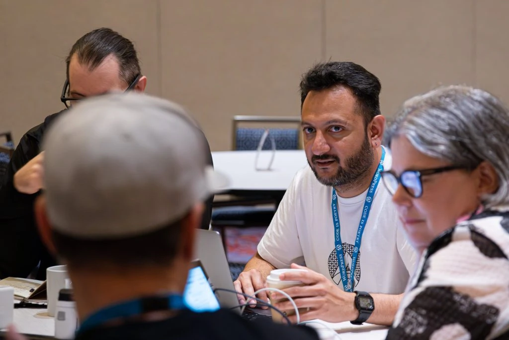 Hostinger Affiliate Partnerships Manager Aditya Remy Shah during a discussion at the Sustainability team table at WordCamp US 2023