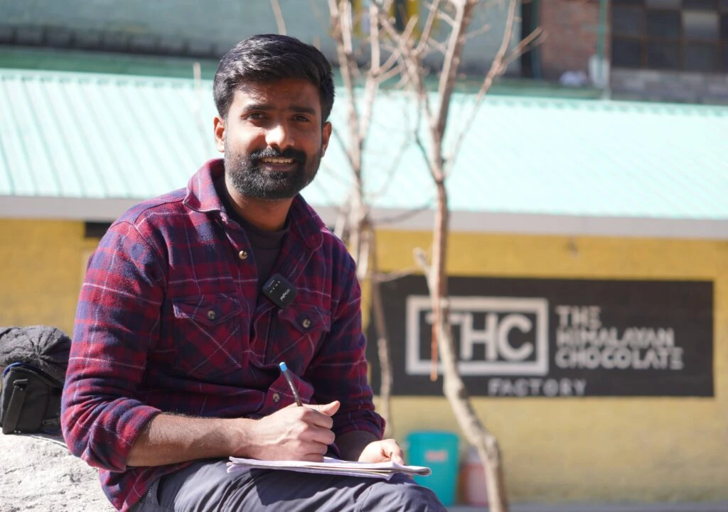 Rohan sitting in front of The Himalayan Chocolate factory