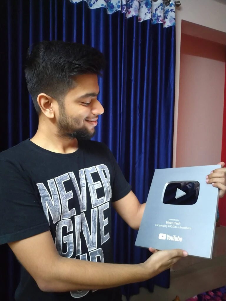 Ansh Bhawnani holding the YouTube Silver Play Button awarded to Bitten Tech for passing 100,000 subscribers