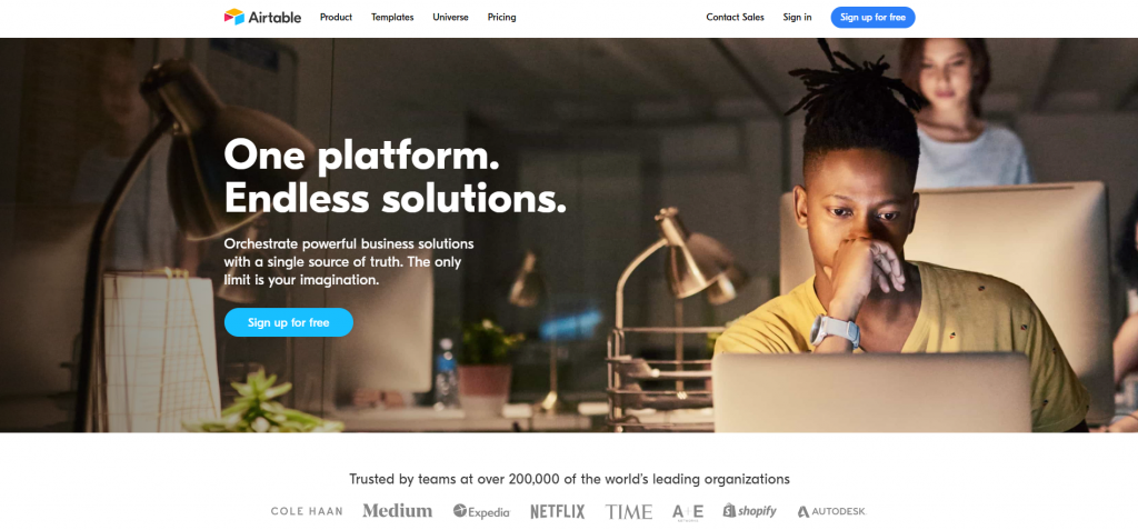 Airtable homepage, featuring one platform and endless solutions with a man working on a laptop