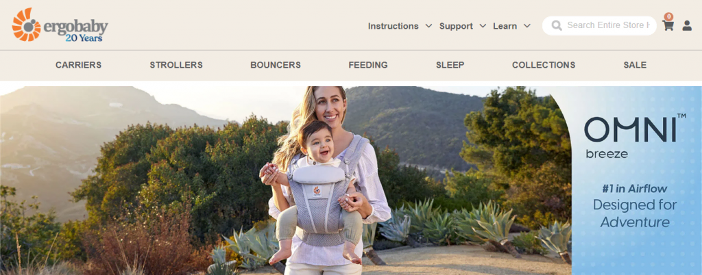 A page on the Ergobaby website showcasing their baby carrier Omni Breeze with a photo of a woman holding a baby using the product.